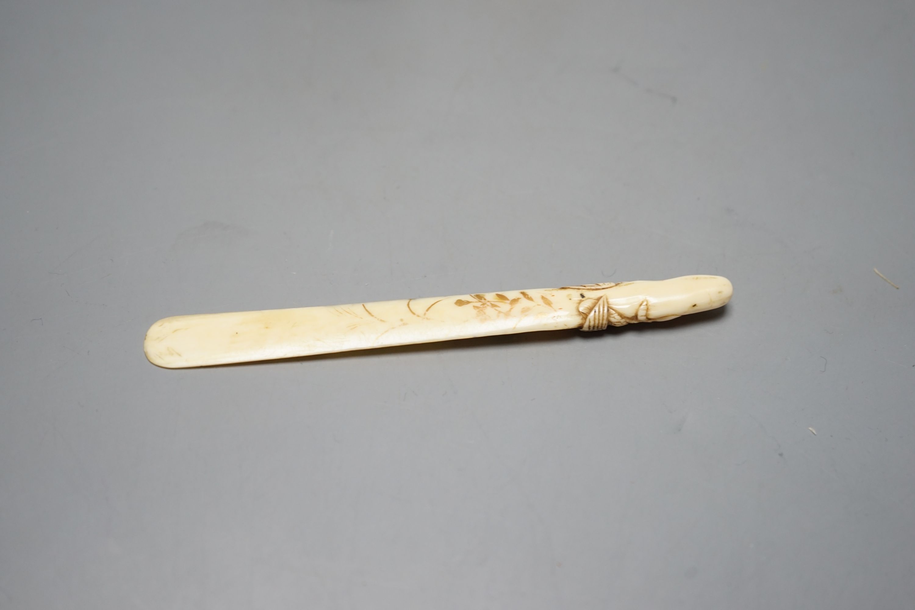 A Japanese face changer, early 20th century, a small okimono of acrobats, Meiji period and an ivory paper knife with lacquer decoration, face changer 8 cms high.